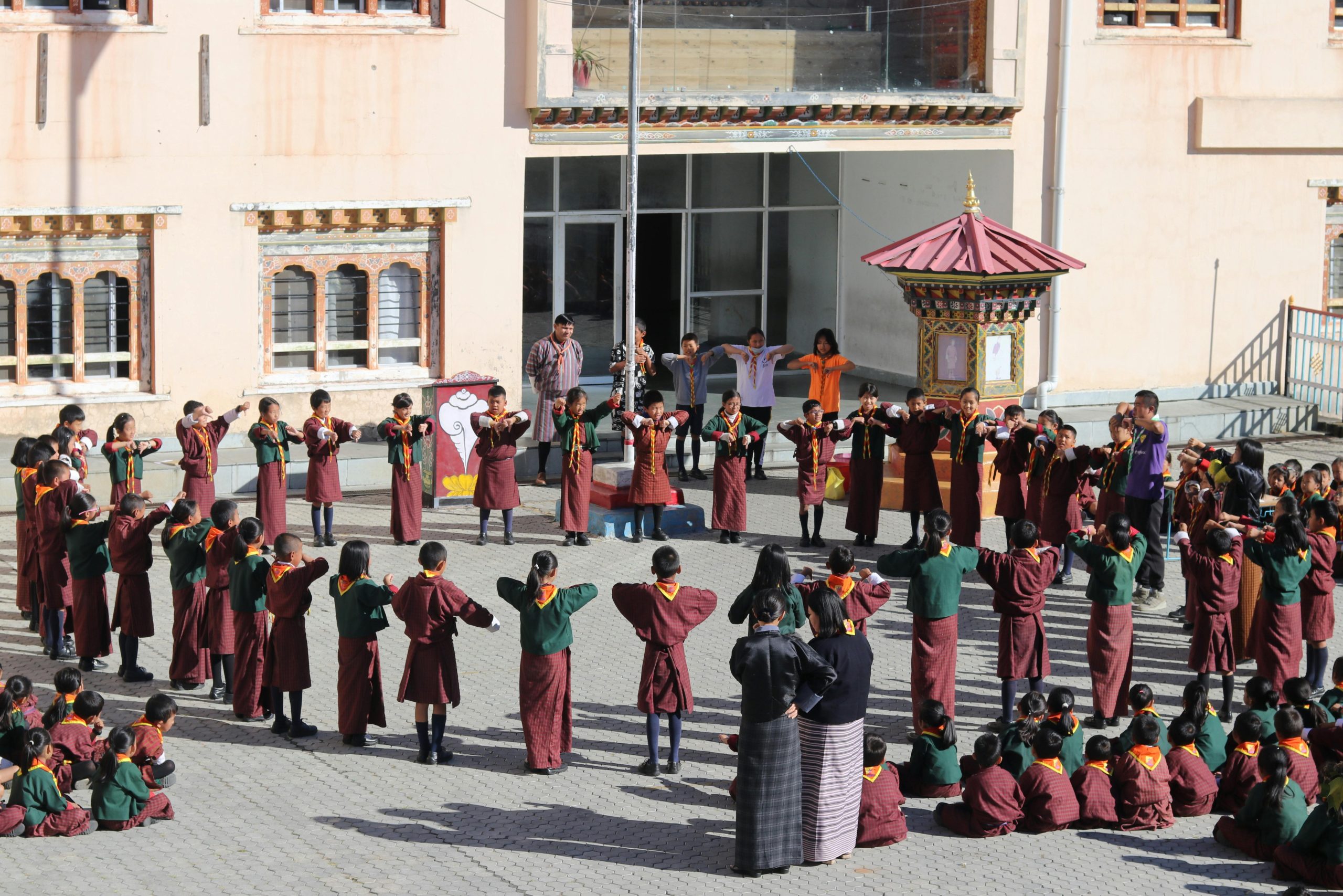 A group of children in traditional clothing participate in a school ceremony in Wangdue Phodrang, Bhutan.