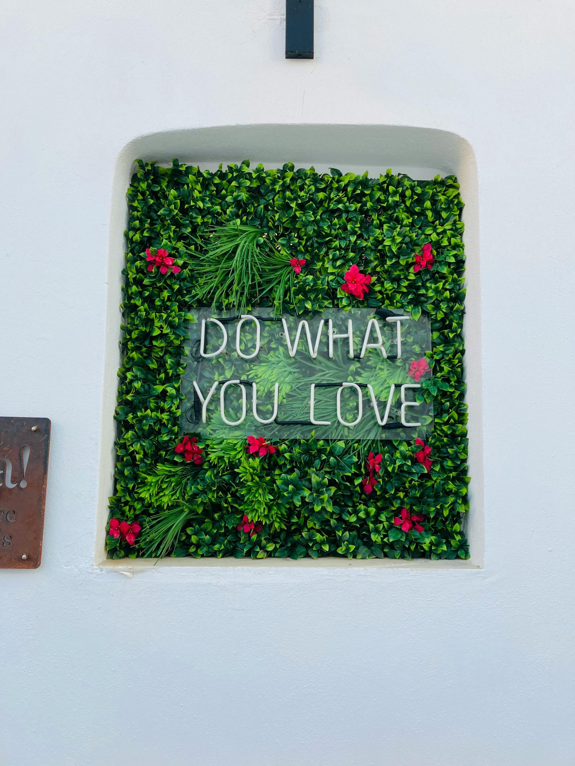 Decorative wall with 'Do What You Love' message in Naousa, Greece. Perfect for inspiration and motivation.